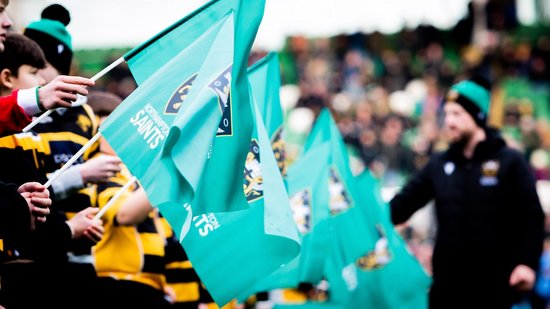 Supporters wave flags at Franklin’s Gardens